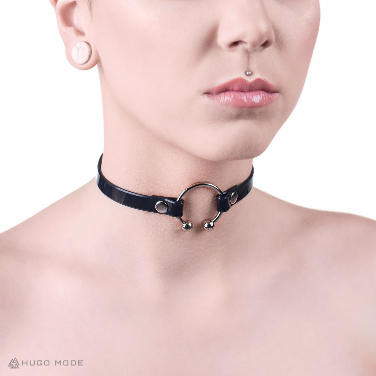 A thin choker, decorated in the front with a piercing ring.