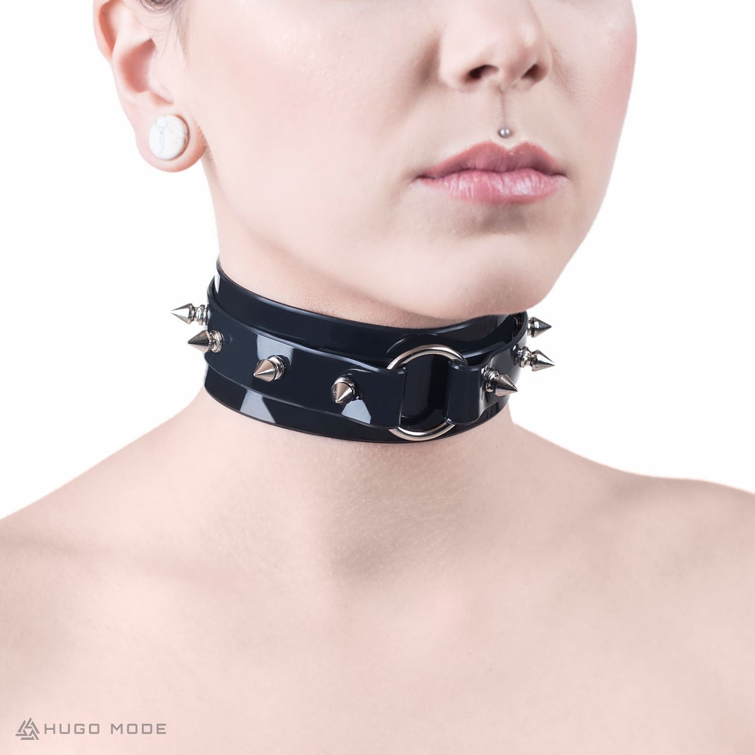 A wide choker with spikes and a ring.