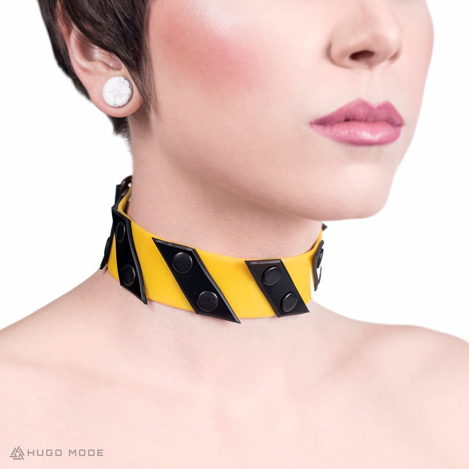A wide yellow-black PVC choker with diagonal stripes resembling a caution tape.