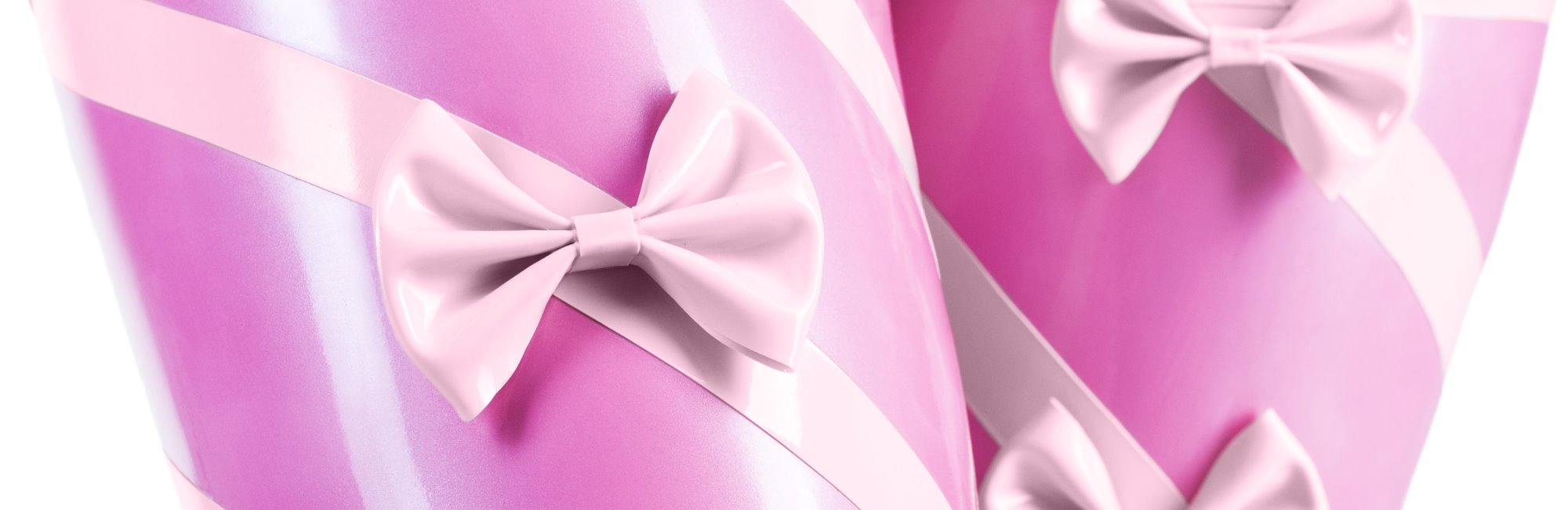 Close-up of pink latex stockings with stripes and bows.